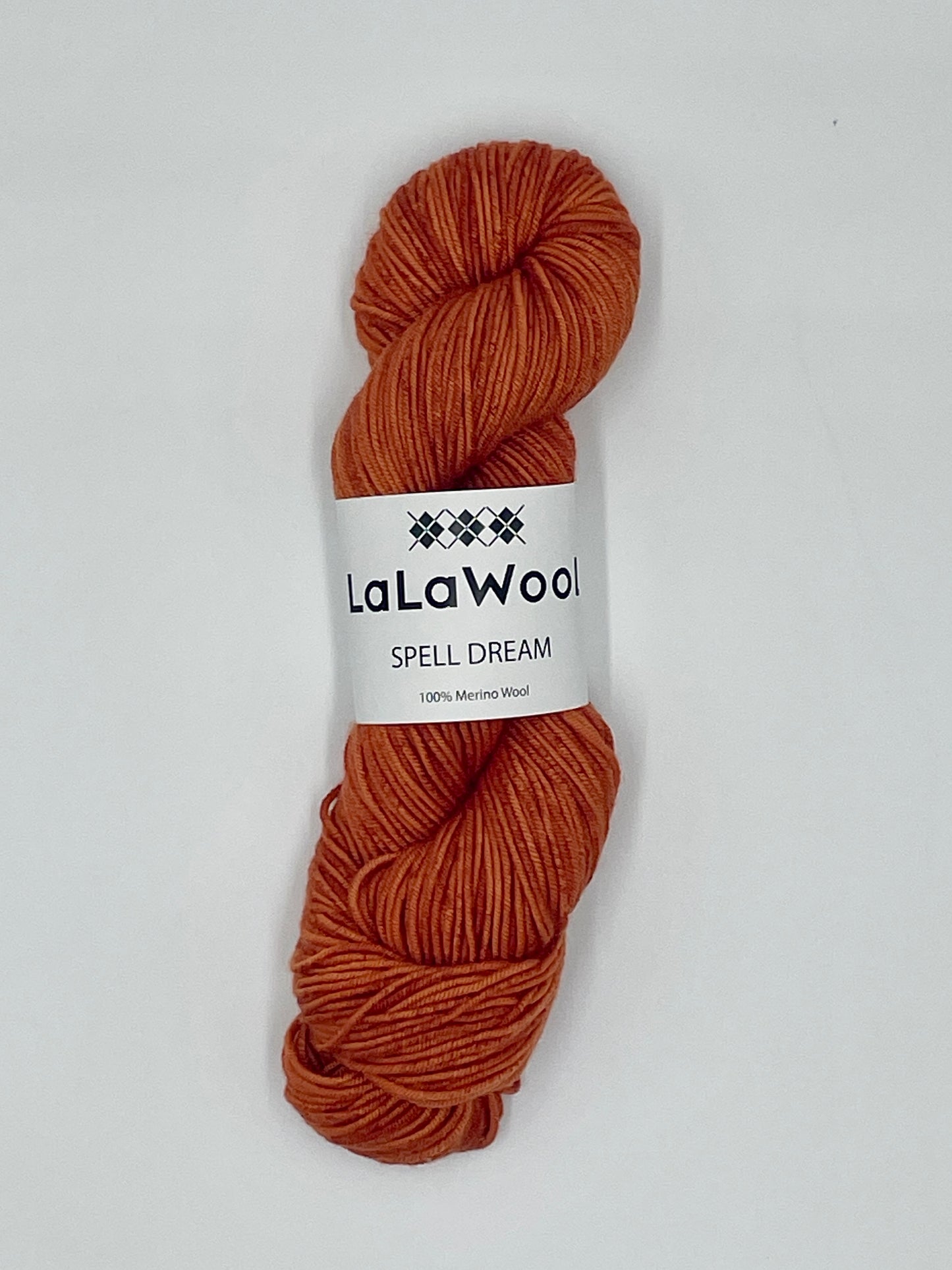 100% Australian Merino Spell Dream Worsted Yarn in Carrot Blood Orange Colour, top view of one skein with LaLaWool tag