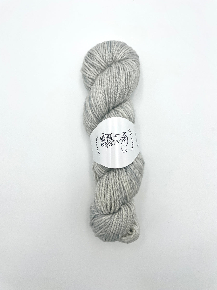 100% Australian Merino Spell Dream Worsted Yarn in Horizon Silver color, top view of one skein with LaLaWool tag