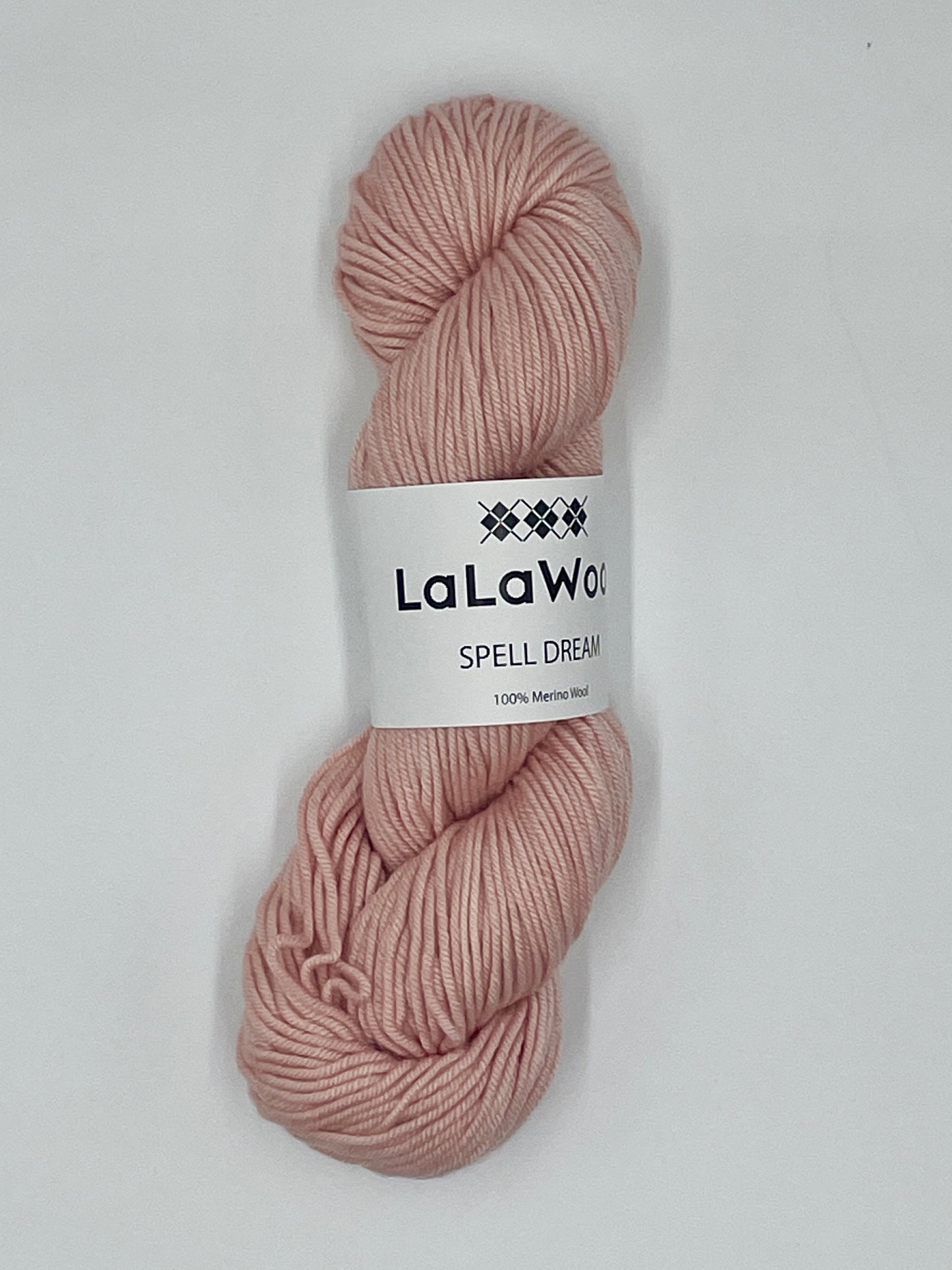 100% Australian Merino Spell Dream Worsted Yarn in Blush Pink Colour, top view of one skein with LaLaWool tag
