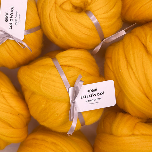 100% Australian Merino Chunky Jumbo Dream Yellow Mango Yarn, top view with tag and multiple balls