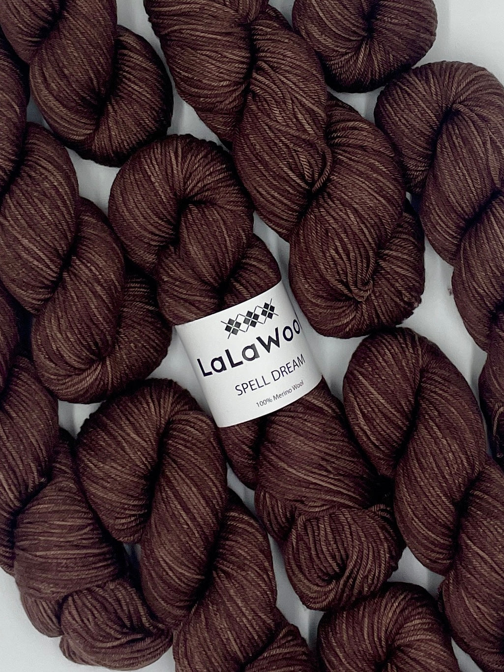 100% Australian Merino Spell Dream Worsted Yarn in Brown Cacao Colour, top view with multiple skeins with LaLaWool tag