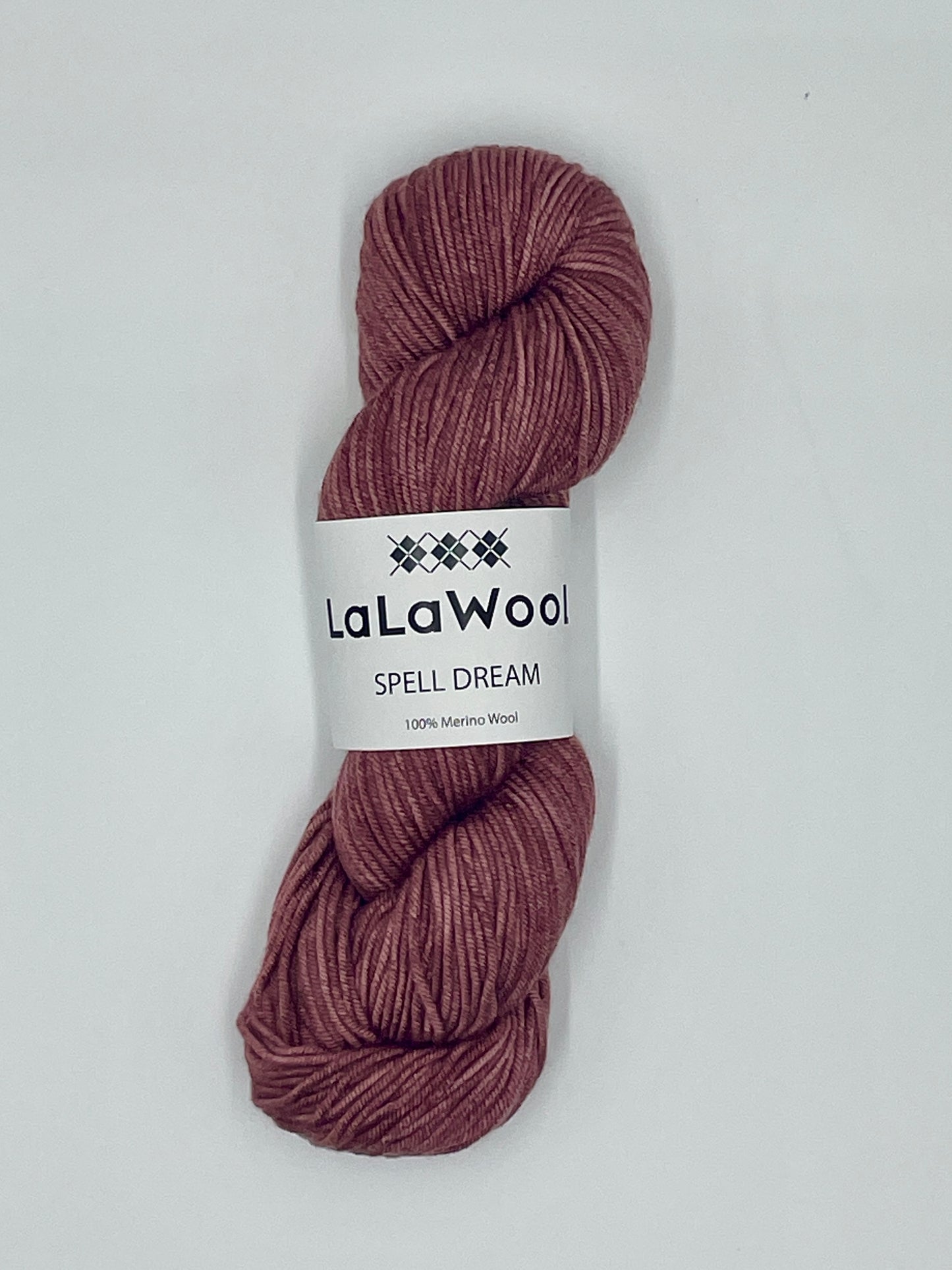 100% Australian Merino Spell Dream Worsted Yarn in Burgundy Rose Colour, top view of one skein with LaLaWool tag