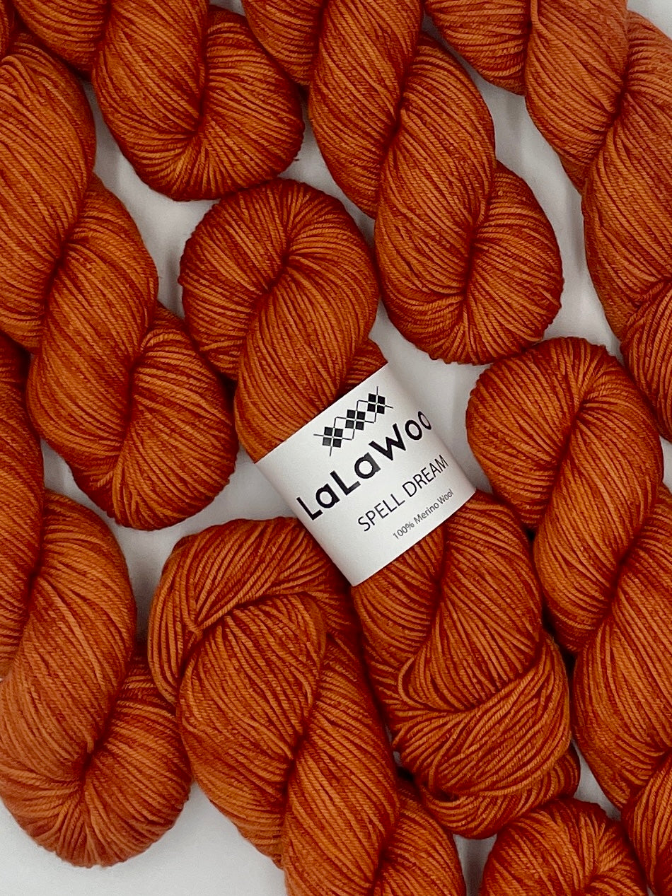 100% Australian Merino Spell Dream Worsted Yarn in Carrot Blood Orange Colour, top view with multiple skeins with LaLaWool tag