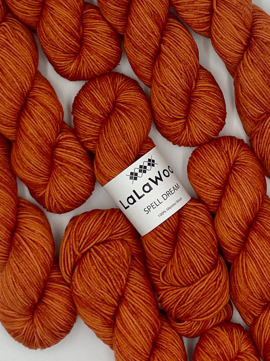 100% Australian Merino Spell Dream Worsted Yarn in Carrot Blood Orange Colour, top view with multiple skeins with LaLaWool tag