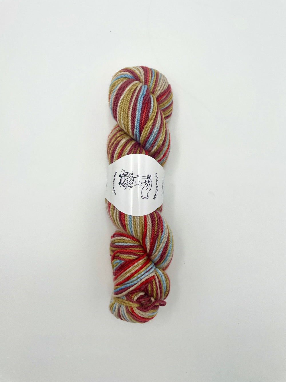 100% Australian Merino Spell Dream Worsted Yarn in Fireworks Multicolour, top view of one skein with LaLaWool tag