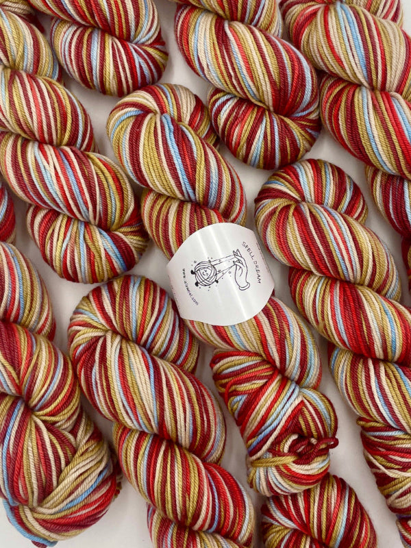 100% Australian Merino Spell Dream Worsted Yarn in Fireworks multicolor, top view with multiple skeins with LaLaWool tag