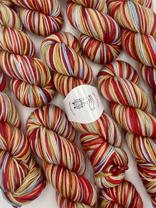 100% Australian Merino Spell Dream Worsted Yarn in Fireworks multicolor, top view with multiple skeins with LaLaWool tag