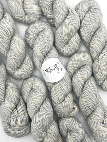 100% Australian Merino Spell Dream Worsted Yarn in Horizon Silver color, top view with multiple skeins with LaLaWool tag