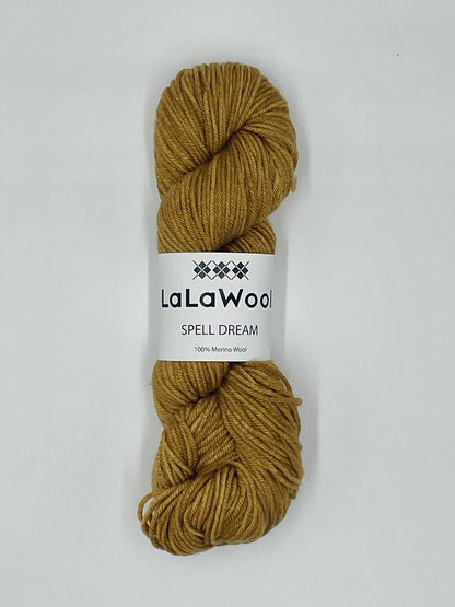 100% Australian Merino Spell Dream Worsted Yarn in Old Gold Yellow Colour, top view of one skein with LaLaWool tag