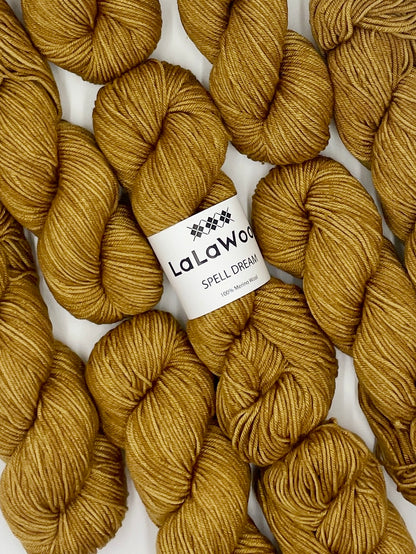 100% Australian Merino Spell Dream Worsted Yarn in Old Gold Colour, top view with multiple skeins with LaLaWool tag