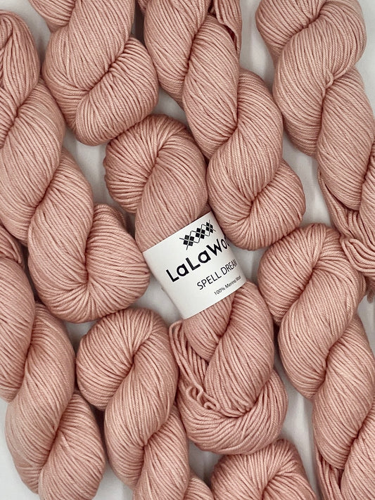 100% Australian Merino Spell Dream Worsted Yarn in Blush Pink Colour, top view with multiple skeins with LaLaWool tag