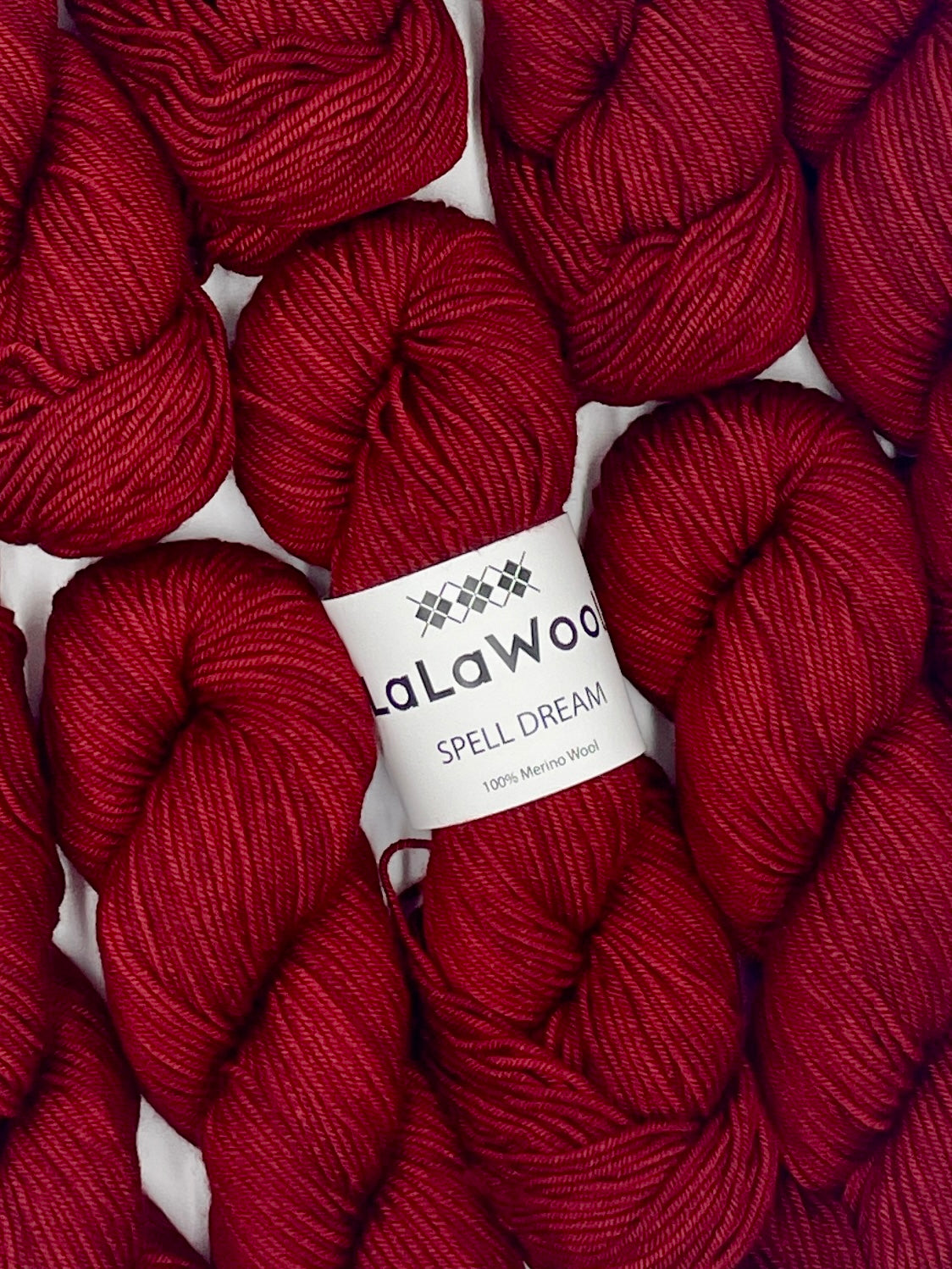 100% Australian Merino Spell Dream Worsted Yarn in Red Bordeaux Colour, top view with multiple skeins with LaLaWool tag