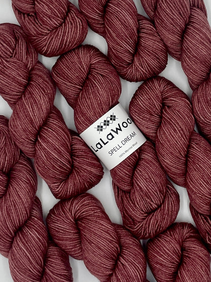 100% Australian Merino Spell Dream Worsted Yarn in Burgundy Rose Colour, top view with multiple skeins with LaLaWool tag