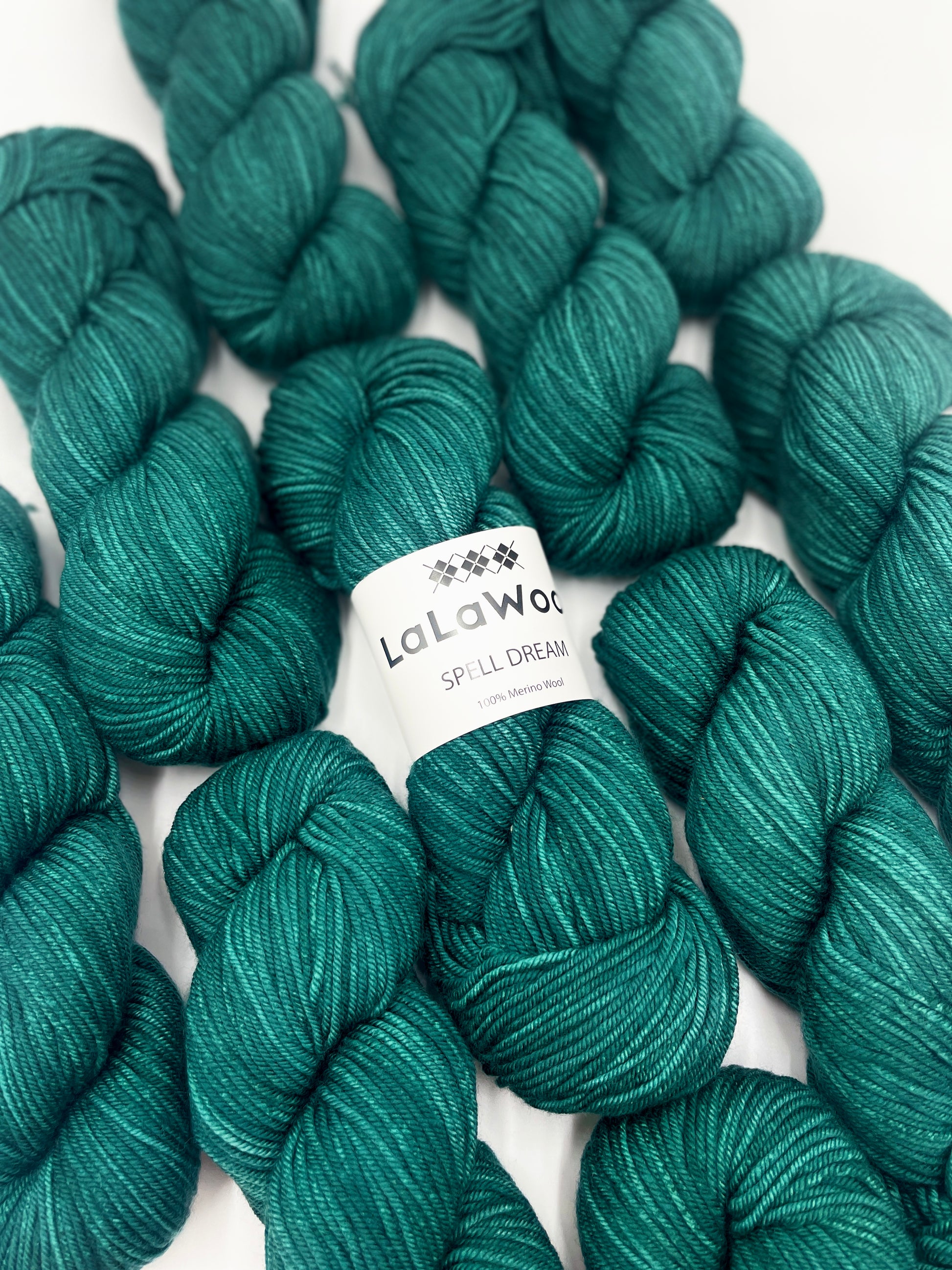 100% Australian Merino Spell Dream Worsted Yarn in Teal Green Colour, top view with multiple skeins with LaLaWool tag